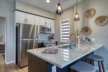 A kitchen with a large island and stainless steel appliances.